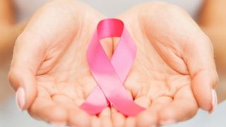 Hands holding a pink ribbon