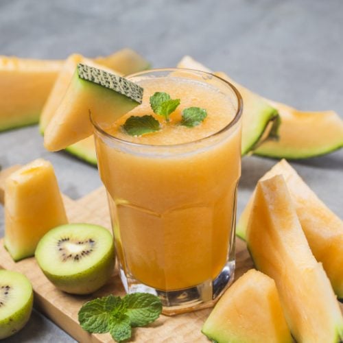 Melon juice with mint in a glass jar on the table