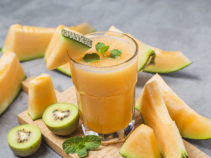 Melon juice with mint in a glass jar on the table