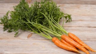 Little carrots with carrot greens on top