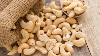 Cashews on a wooden spoon kept on the table
