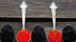 Various spoons with red and black caviar in them