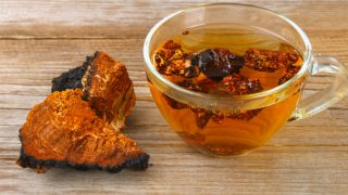 Chaga tea in a cup next to chaga