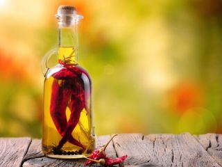 chilioil Close up of a chili oil bottle, infused with whole chilis and black pepper