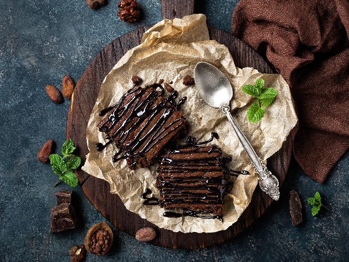 A flat lay pic of delicious chocolate brownies kept atop a table