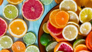 A variety of sliced citrus fruits on a surface