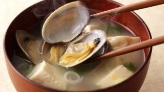Piping hot clam soup in a bowl with chopsticks