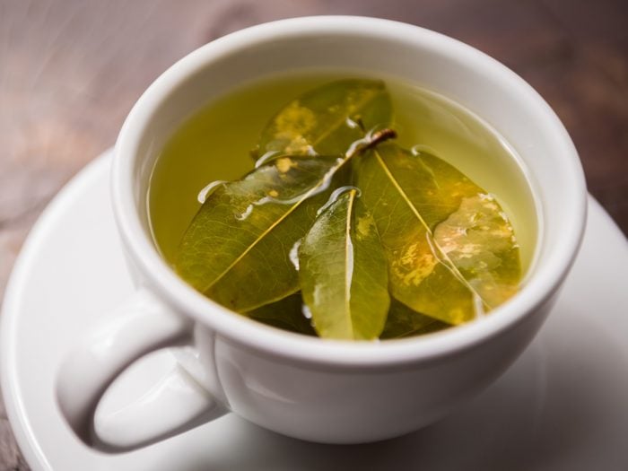 A white cup filled to the brim with coca tea