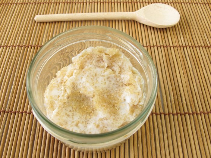 A bowl containing coconut oil sugar scrub