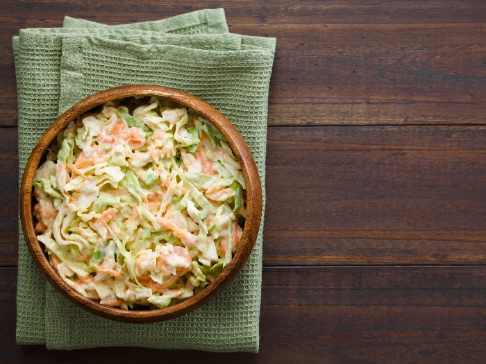 Coleslaw made of freshly shredded white cabbage and grated carrot with homemade mayonnaise-based salad dressing