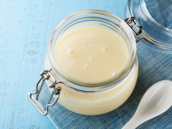 A close-up shot of a container of condensed milk