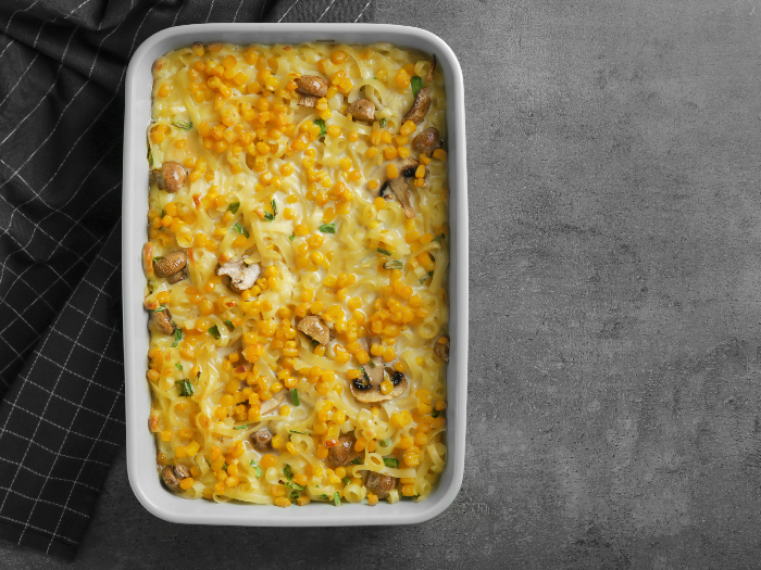 A flatlay pic of tasty casserole with corn in a baking dish