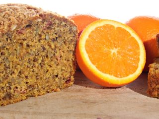 cranberryorangebread cranberry orange bread next to a halved orange on a counter