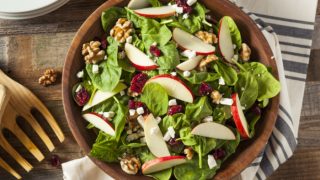 apple cranberry walnut salad in a wooden bowl
