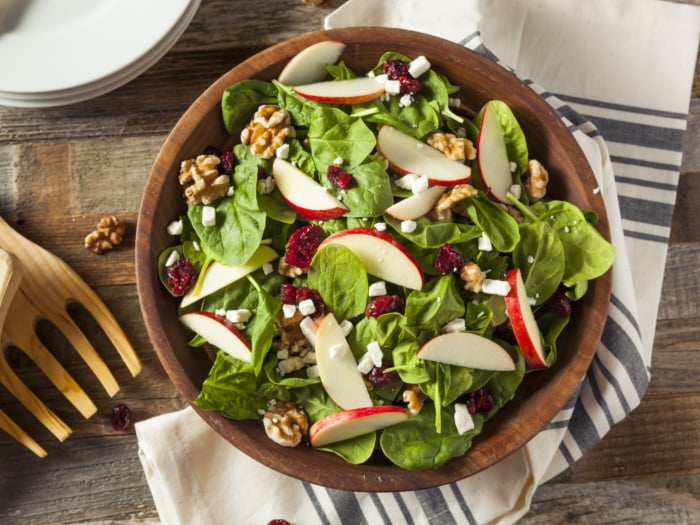 apple cranberry walnut salad in a wooden bowl