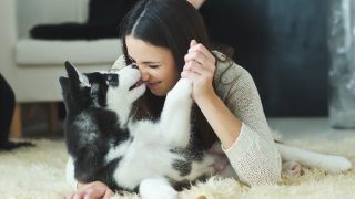 A woman cuddling with her dog