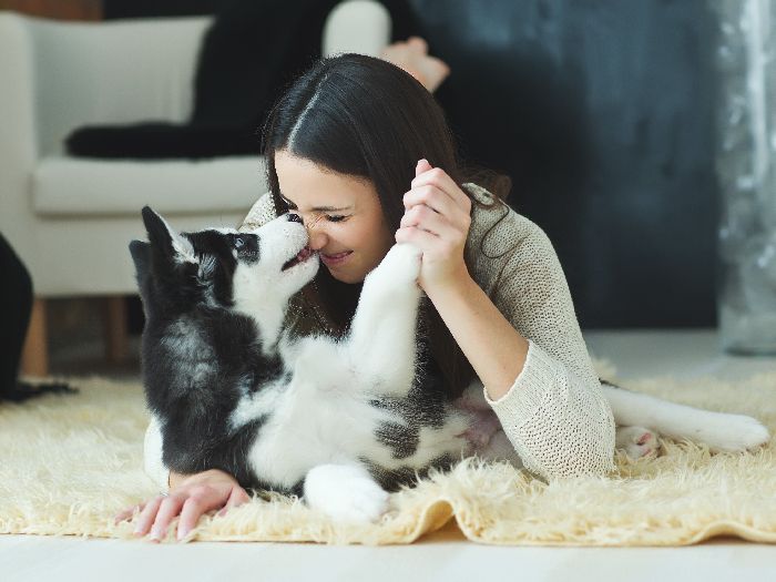 A woman cuddling with her dog