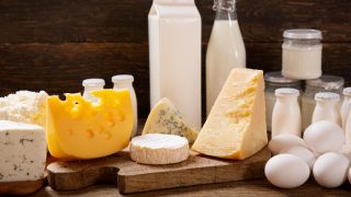 Dairy products on a wooden surface against a dark background