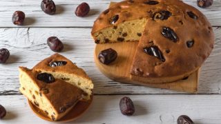 Date cake on a white wooden background