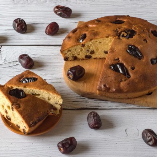 Date cake on a white wooden background