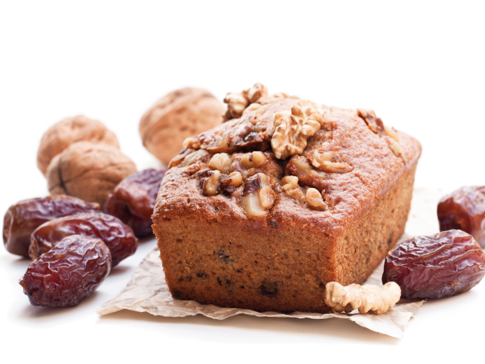 Homemade date and walnut loaf cake isolated on white background