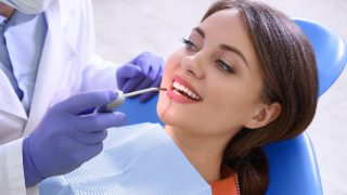A dentist working with a patient in a clinic