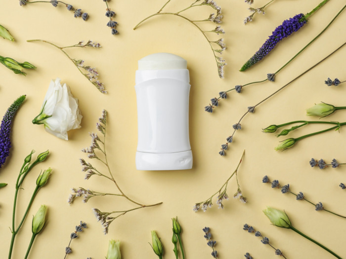 Flatline picture of a deodorant stick surrounded by lavender flowers.