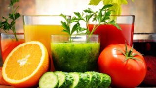 A close up shot of cucumber, tomato and orange juices