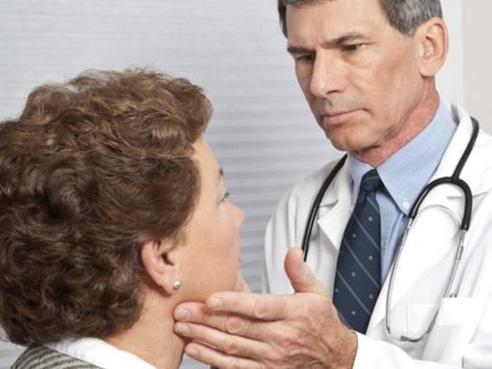 Doctor with his patient checking for symptoms of diphtheria
