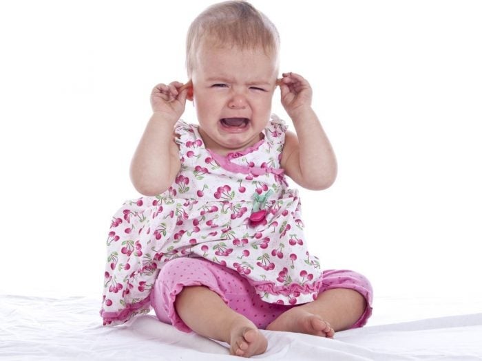 A crying infant girl with an earache