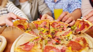 Group of people sharing a pizza