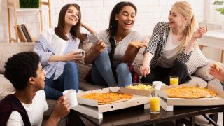 Group of teenagers eating together