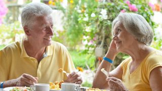 Elderly couple sharing a meal and talking