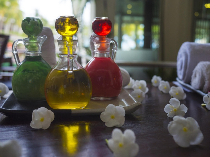 Three bottles containing different oils on a tray