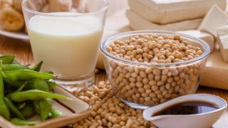 Close-up of peas, legumes, milk and a bowl of dark-colored syrup