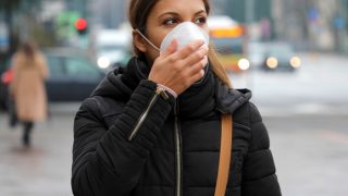 Woman on street wearing a protective mask