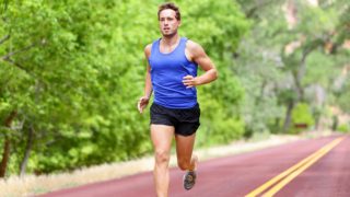 A man running on a track against a blurred background