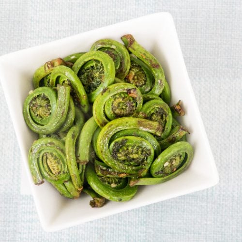 Cooked ostrich fiddleheads ferns with garlic