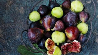 A flat lay pic of a bowl of figs