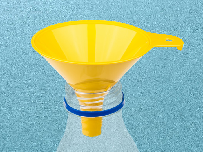 Close-up of a yellow funnel placed on top of a plastic bottle on a light blue background.