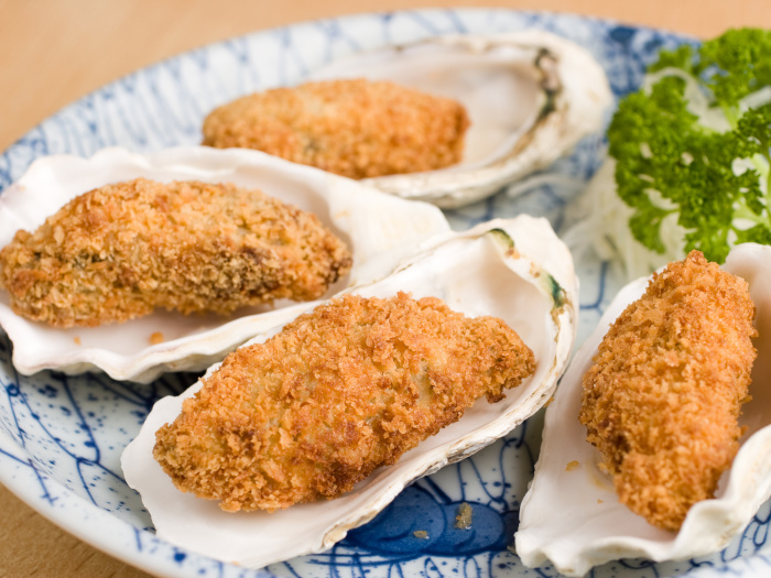 Deep fried breadcrumbed oysters in a half shell.