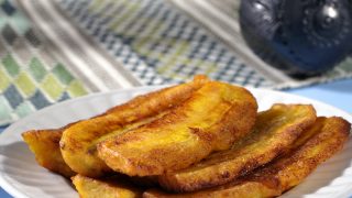 Stack of fried sliced plantain bananas on plate