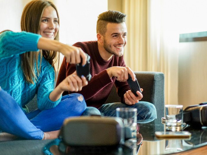 A boy and a girl sitting and playing a video game