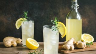 A glass of ginger ale in the middle surrounded by other ingredients
