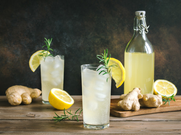 A glass of ginger ale in the middle surrounded by other ingredients