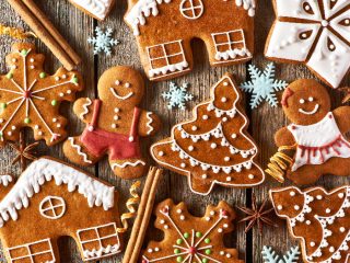 gingerbreadthree Gingerbread cookies, like a house, man, Christmas tree kept atop a wooden desk