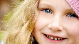 A headshot of a little girl smiling