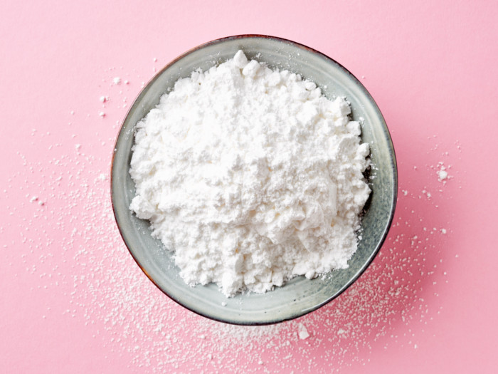 Glucose powder in a bowl on a pink counter