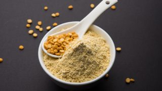 Gram flour in a bowl with a spoonfull of Bengal gram