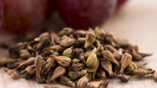 Close up of grape seeds on a wooden table